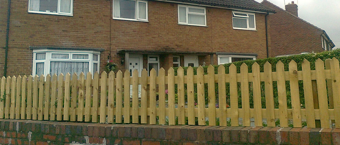 Garden boundary wicket fence fixed to wall
